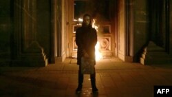 Russian artist Pyotr Pavlensky poses after setting fire to the doors of the headquarters of the FSB security service, the successor to the KGB, in central Moscow, Nov. 9, 2015. 