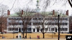 FILE - Students walk across the Dartmouth College campus green in Hanover, N.H., March 12, 2012.