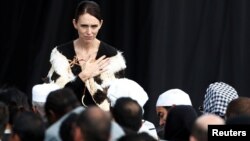 New Zealand's Prime Minister Jacinda Arden gestures to relatives of victims of the mosque attacks during the national remembrance service, at Hagley Park in Christchurch, New Zealand, March 29, 2019.