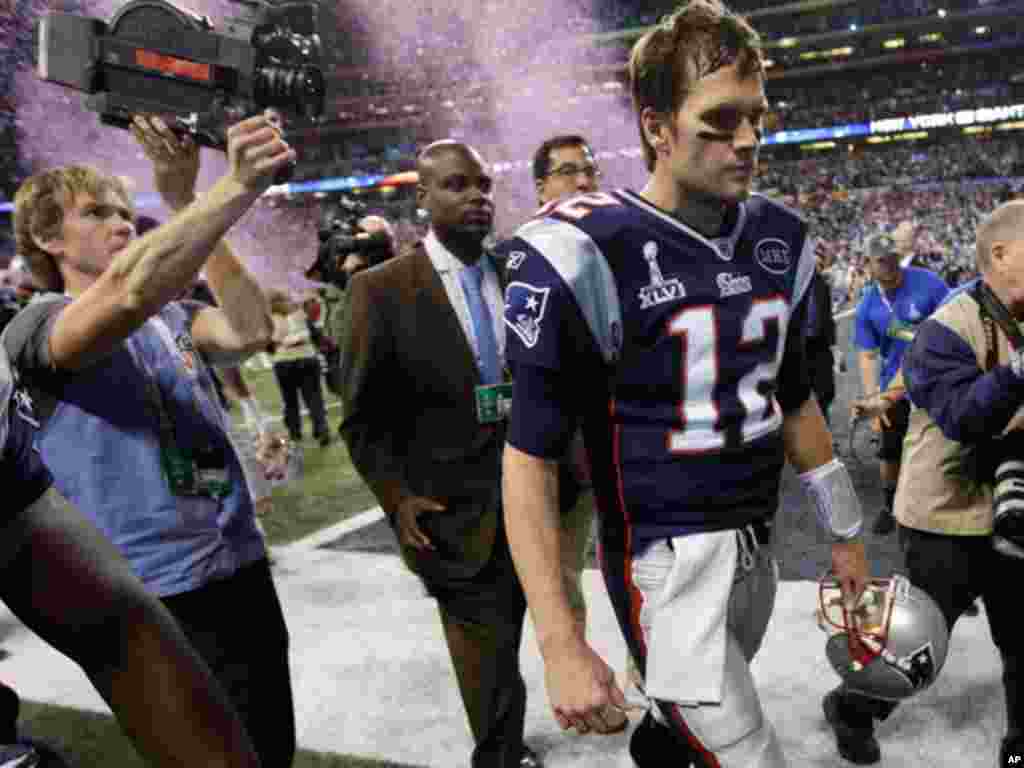 New England Patriots quarterback Tom Brady walks off the field after the Patriots' 21-17 loss to the New York Giants in the NFL Super Bowl XLVI football game, Sunday, Feb. 5, 2012, in Indianapolis