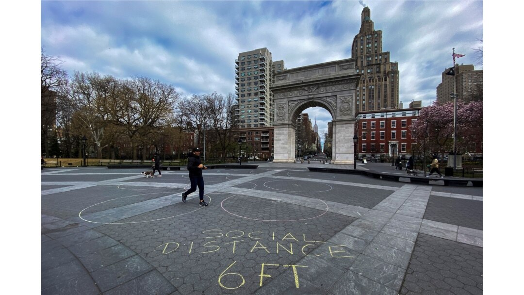 People walk around Washington square park as the coronavirus disease (COVID-19) outbreak continues in New York, U.S., March 22, 2020.