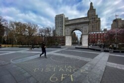 People walk around Washington square park as the coronavirus disease (COVID-19) outbreak continues in New York, U.S., March 22, 2020.