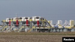 FILE - Idled drilling rigs owned by contractor Helmerich & Payne International Drilling Company sit on a lot in Seguin, Texas, Jan. 13, 2016.