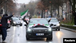 People gather on the streets, after Syrian rebels announced that they have ousted Syria's Bashar al-Assad, in Berlin