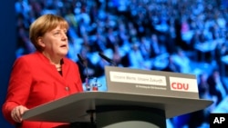 FILE - Germany German Chancellor and Chairwomen of the CDU, Angela Merkel, speaks during a party conference of the Christian Democratic Union (CDU) in Essen, Germany, Dec. 6, 2016.