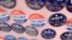 FILE - Biden for President campaign buttons are for sale beside "Impeach Trump Now!" buttons as U.S. Democratic presidential candidate and former Vice President Joe Biden meets union workers at the Teamsters Local 249 hall in Pittsburgh, April 29, 2019.