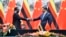 Zimbabwean President Emmerson Mnangagwa, left, shakes hands with Chinese President Xi Jinping as they pose for the media after a signing ceremony at the Great Hall of the People in Beijing, China, April 3, 2018.