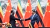 Zimbabwean President Emmerson Mnangagwa, left, shakes hands with Chinese President Xi Jinping as they pose for the media after a signing ceremony at the Great Hall of the People in Beijing, China, April 3, 2018.