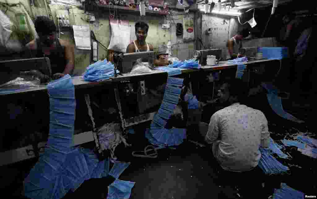 Workers make protective masks inside a workshop in Mumbai, India, March 14, 2020.