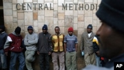 Refugees, mostly from Zimbabwe stand outside the Central Methodist Church in Johannesburg, 30 Jun 2008