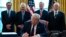 President Donald Trump signs the coronavirus stimulus relief package in the Oval Office at the White House in Washington, March 27, 2020.