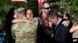 Natalie Henry-Howell, second from left, and Thomas Howell, right, parents of Riley Howell, are comforted after a memorial service for Riley Howell in Lake Junaluska, N.C., Sunday, May 5, 2019. Family and hundreds of friends and neighbors are remembering H