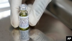 FILE - A pharmacist holds a vial of lenacapavir, a new Gilead-made HIV prevention injectable drug, at the Desmond Tutu Health Foundation's Masiphumelele Research Site, in Cape Town, South Africa, July 23, 2024.