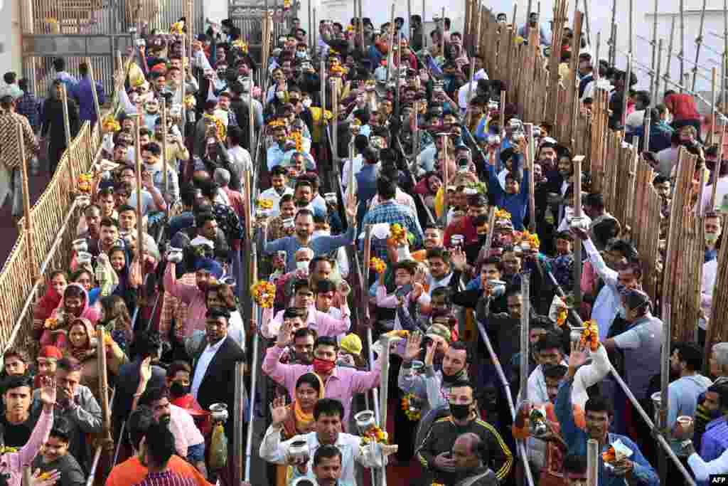 Hindu devotees wait in lines to perform rituals to a Shiva Lingam, a stone sculpture representing the phallus of the Hindu deity Shiva, on the occasion of the Maha Shivaratri festival, at the Shivala Bhaiyaan temple in Amritsar, India.