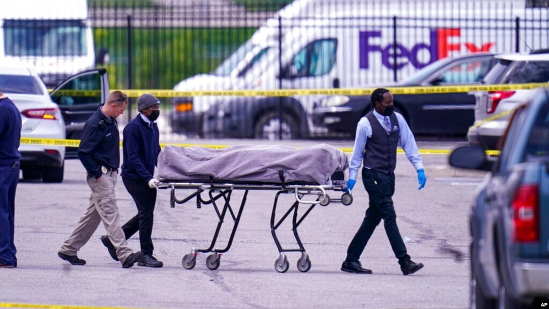 A body is taken from the scene where multiple people were shot at a FedEx Ground facility in Indianapolis, April 16, 2021. 