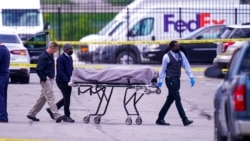 A body is taken from the scene where multiple people were shot at a FedEx Ground facility in Indianapolis, April 16, 2021.