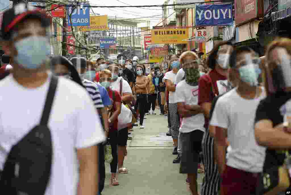 Devotees of the Black Nazarene wait for their turn to enter the plaza outside the Quiapo church in downtown Manila, Philippines, on the eve of feast day. Several Black Nazarene replicas have been placed around churches to encourage devotees to pray at the