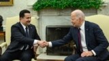 FILE—US President Joe Biden (R) shakes hands with the Prime Minister of Iraq Mohammed Shia al-Sudani in the Oval Office of the White House in Washington, DC on April 15, 2024.