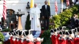 U.S. President Barack Obama (R) and Pope Francis watch onstage as the "Old Guard" fife and drum corps marches past during an official welcome ceremony on the South Lawn at the White House in Washington, Sept. 23, 2015. 