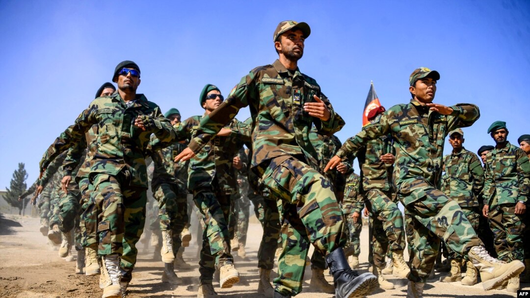 FILE - Afghan National Army soldiers march during a ceremony at a military base in the Guzara district of Herat province, Oct. 11, 2020. 