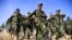 FILE - Afghan National Army soldiers march during a ceremony at a military base in the Guzara district of Herat province, Oct. 11, 2020. 