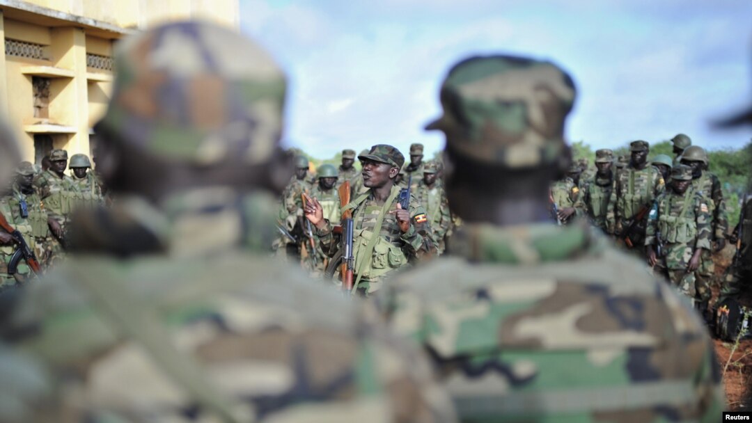 FILE - Troops from the African Union Mission in Somalia (AMISOM) gather for a briefing in Somalia, Oct. 18, 2012. Five African Union peacekeepers in Somalia were arrested for allegedly trying to sell military supplies.