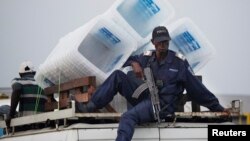 Un policier est assis sur un minibus, à Kinshasa, en République démocratique du Congo, le 1er décembre 2011.