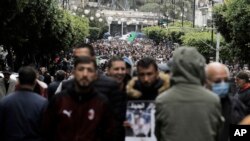 FILE - Algerians demonstrate in the streets of Algiers, April 16, 2021. A crowd of protesters marched in the streets of Algeria capital Algiers in support for the Hirak pro-democracy movement.