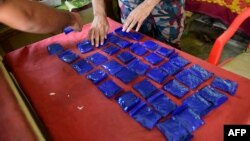 A Bangladesh Border Guard (BGB) lays out small bags of the drug "yaba" recovered from a passenger bus in a search at a checkpost along the Teknaf-Cox's Bazar highway in Teknaf, April 6, 2018.
