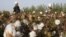 FILE - Migrant workers pick cotton in a field in Korla, Oct. 10, 2006, in a town on the edge of the Tarim Basin and the Taklamakan Desert, south of Urumqi, capital of China's far west Xinjiang Uighur Autonomous Region. 