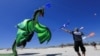 American, Tony Jetland holds his kite's strings during a practice run at Dolphin Beach ahead of this weekend's 30th Cape Town International Kite Festival in Cape Town, South Africa, Oct. 22, 2024.