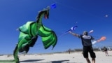 American, Tony Jetland holds his kite's strings during a practice run at Dolphin Beach ahead of this weekend's 30th Cape Town International Kite Festival in Cape Town, South Africa, Oct. 22, 2024.