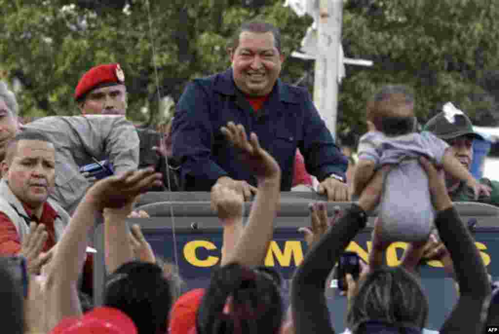 Venezuela's President Hugo Chavez, top center, smiles upon his arrival to Guanare, Venezuela, Friday, Jan. 6, 2012. Chavez traveled to the Sanctuary of the Virgin of Coromoto to fulfill a pledge and to attend a mass to pray for his health. (AP Photo/Ferna
