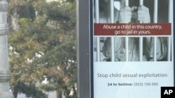 A sign warns against child sexual exploitation on the riverfront in Phnom Penh, Cambodia, popular with tourists, Wednesday, March 2, 2005. (AP Photo/Andy Eames)