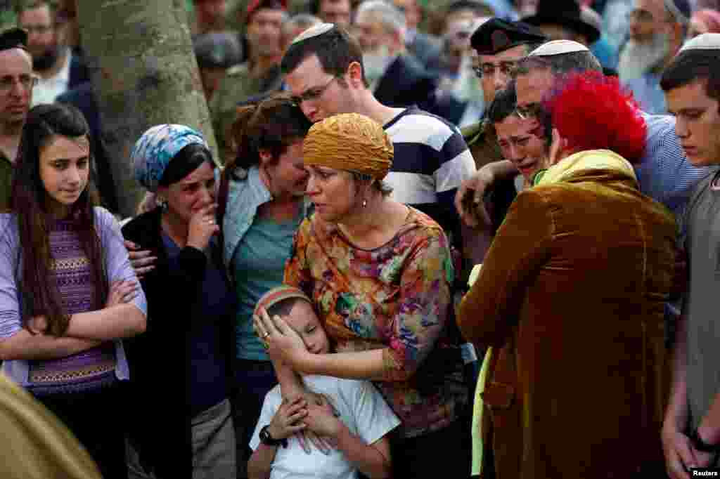 The mother (C), other relatives and friends attend the funeral of Israeli soldier Elhai Taharlev. The Israeli military said he was killed when a car driven by a Palestinian deliberately rammed two Israeli soldiers, killing Taharlev and injuring another, in the occupied West Bank, in Jerusalem.