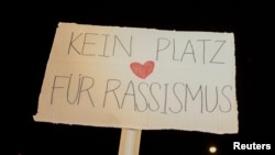 A placard reads "No place for racism" during a protest against the Freedom Party after general elections in Vienna, Austria, Oct. 3, 2024.