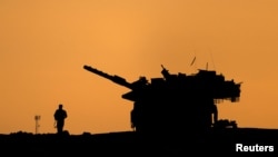 The silhouettes of a military vehicle and a soldier are seen near the Gaza border, amid the ongoing conflict in Gaza between Israel and Hamas, in Israel, Dec. 16, 2024. 