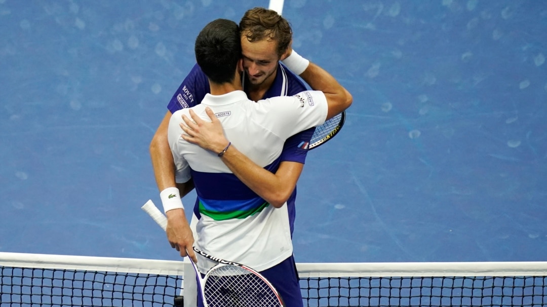 Daniil Medvedev of Russia, right, poses after winning the final