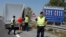 FILE - Austrian police officers control cars arriving to Austria at a checkpoint in the village of Nickelsdorf, Aug. 31, 2015.
