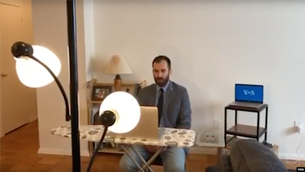 Transforming his living room into a self-isolation studio for live TV interviews to affiliate stations in Bosnia, VOA&rsquo;s Bosnian service journalist, Dino Jahic, uses his ironing board to double as an anchor desk to set up an in-home camera on his laptop for live broadcasts.