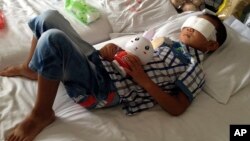 Guo Bin lies on a bed in a hospital as he recuperates from an attack in the rural area of Linfen city that left him blind, in Taiyuan in northwest China's Shanxi province, Aug. 28, 2013.
