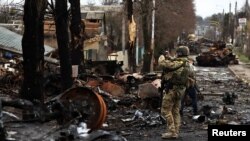 在基輔地區的烏克蘭軍人用手機拍攝被摧毀的俄羅斯坦克及軍車。