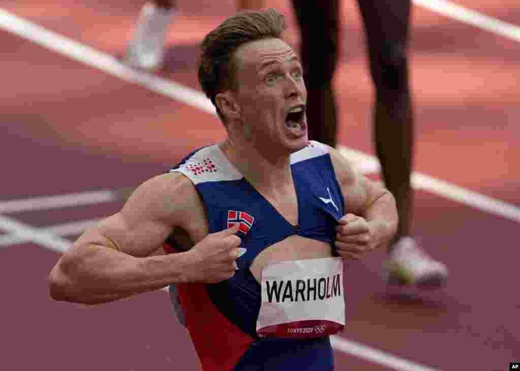 Karsten Warholm of Norway celebrates as he wins the gold medal in the final of the men&#39;s 400-meter hurdles at the 2020 Summer Olympics in Tokyo, Japan. 