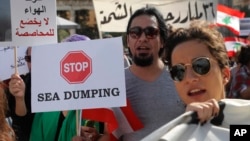 Lebanese protesters chant slogans during a protest against corruption and criticizing long-serving politicians for failing to form a government, in Beirut, Lebanon, Nov. 22, 2018.