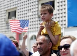 A boy looks on during the 20th anniversary of the deployment of NATO Troops in Kosovo in Pristina, Kosovo, June 12, 2019.