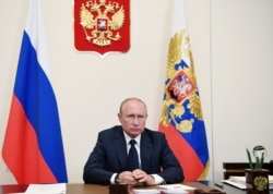 FILE - Russian President Vladimir Putin is seen during a teleconference at the Novo-Ogaryovo state residence, outside Moscow, May 11, 2020.