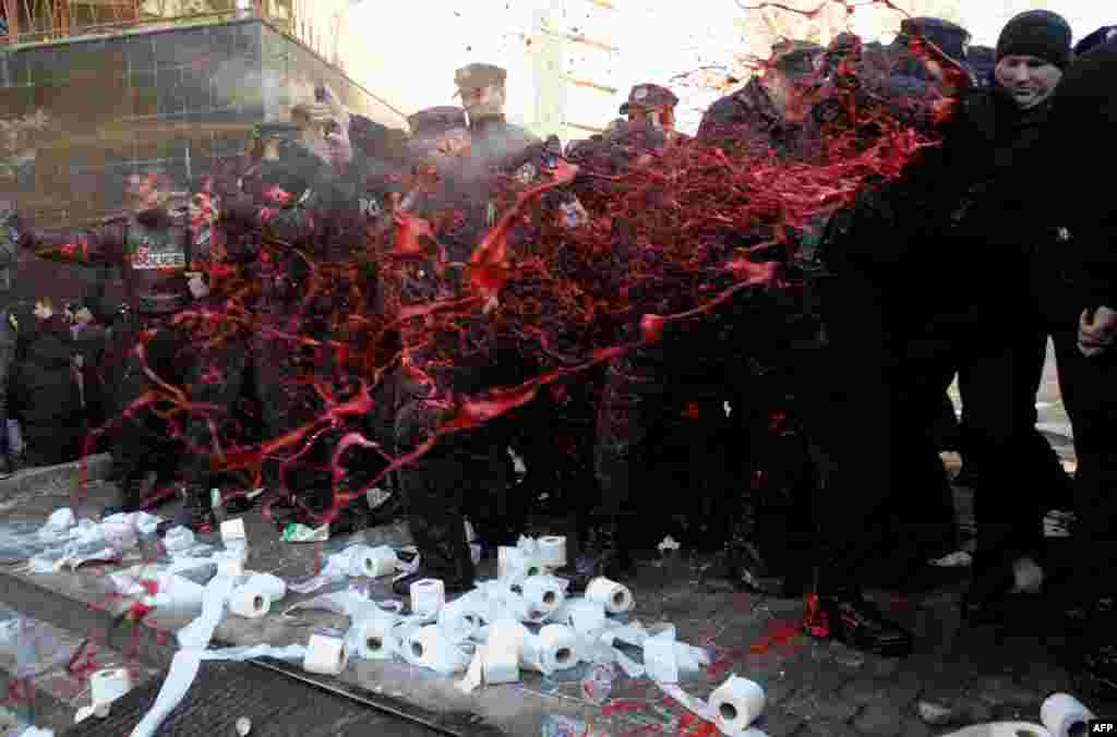 Protesters splash police officers with red paint as demonstrators gather in Pristina to demand the resignation of the dean and a number of teaching staff of Pristina University, Kosovo. Five policemen and about a dozen students were injured when anti-riot police used pepper spray and batons to disperse protesters who have been peacefully blocking the rectorate of Pristina University for seven days.