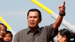 Cambodia's Prime Minister Hun Sen, center, gestures during a ceremony inaugurating the country's longest bridge in Neak Loeung, southeast of Phnom Penh, Cambodia, Wednesday, Jan. 14, 2015. 