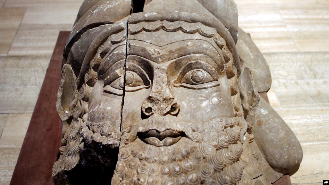 FILE - The head of a winged bull made out of limestone was restored and displayed at the Iraqi National Museum in Baghdad. Now much of that archaeological wealth is under the control of extremists from the Islamic State group, Sept. 15, 2014.
