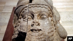 FILE - The head of a winged bull made out of limestone was restored and displayed at the Iraqi National Museum in Baghdad. Now much of that archaeological wealth is under the control of extremists from the Islamic State group, Sept. 15, 2014.